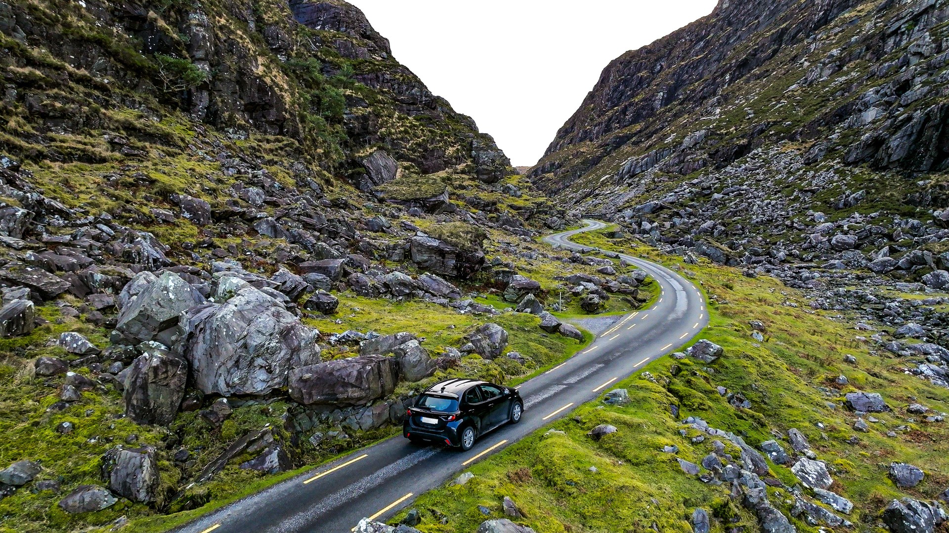 Aerial view of Gap of Dunloe, County Kerry in Ireland,Aerial view of scenic mountain pass, aerial nature and road view, aerial view of winding road, nature relax video, car driving the winding road between the mountain