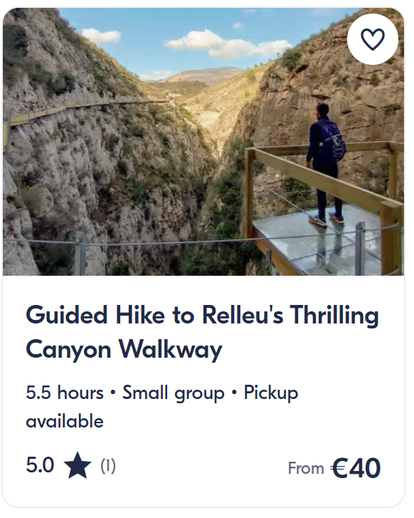 Hiker standing on glass canyon walkway in Relleu overlooking dramatic rocky gorge – guided small group hiking tour.
