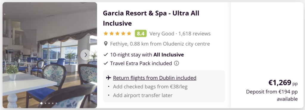 Luxury hotel in Marmaris with large outdoor swimming pool, sun loungers and palm trees, all inclusive holiday package with flights included